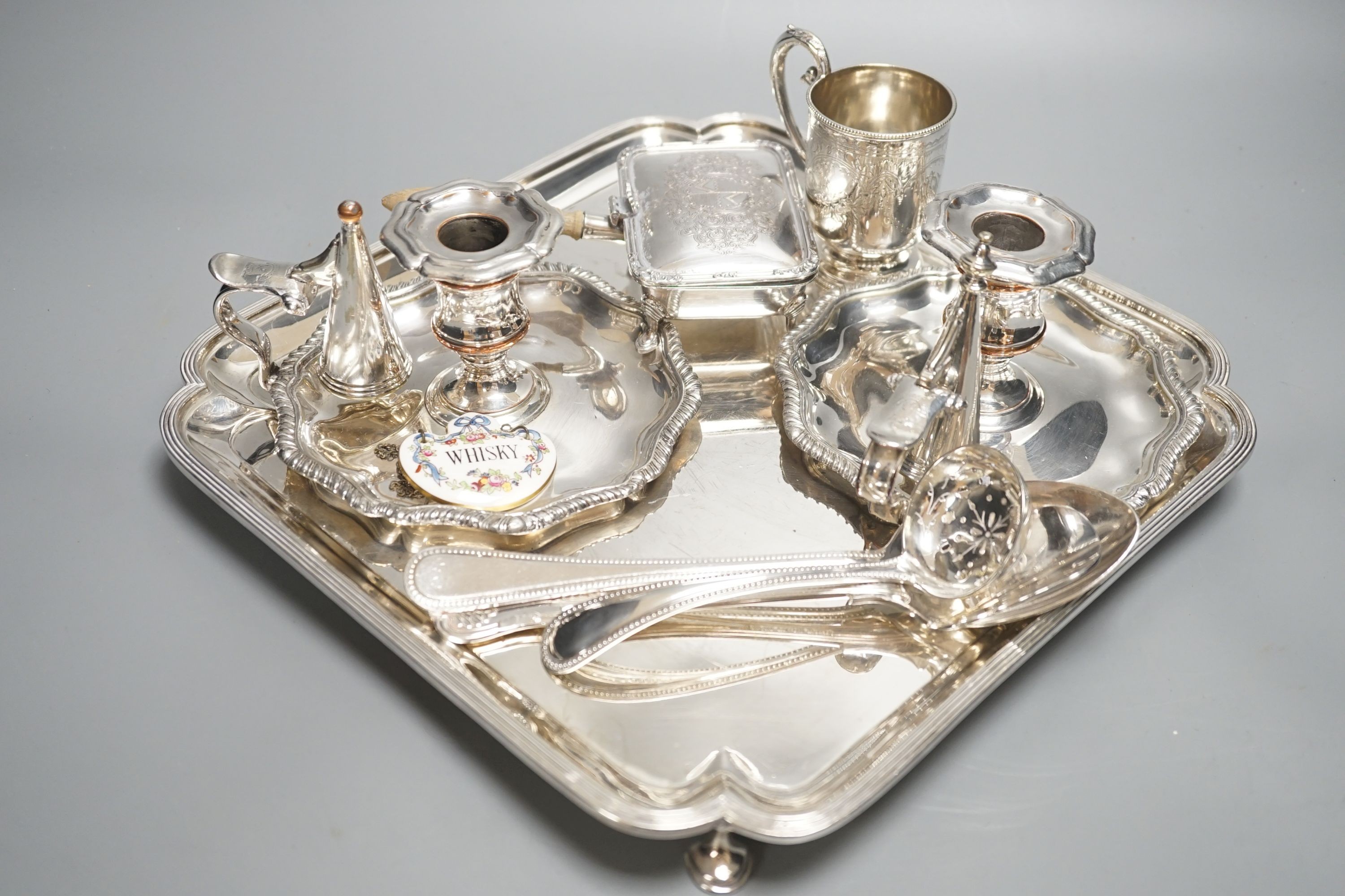 A plated salver, a pair of chambersticks and other plated flatwares